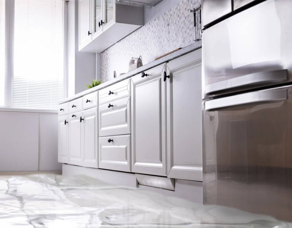 Flooded kitchen inside a house showing severe water damage